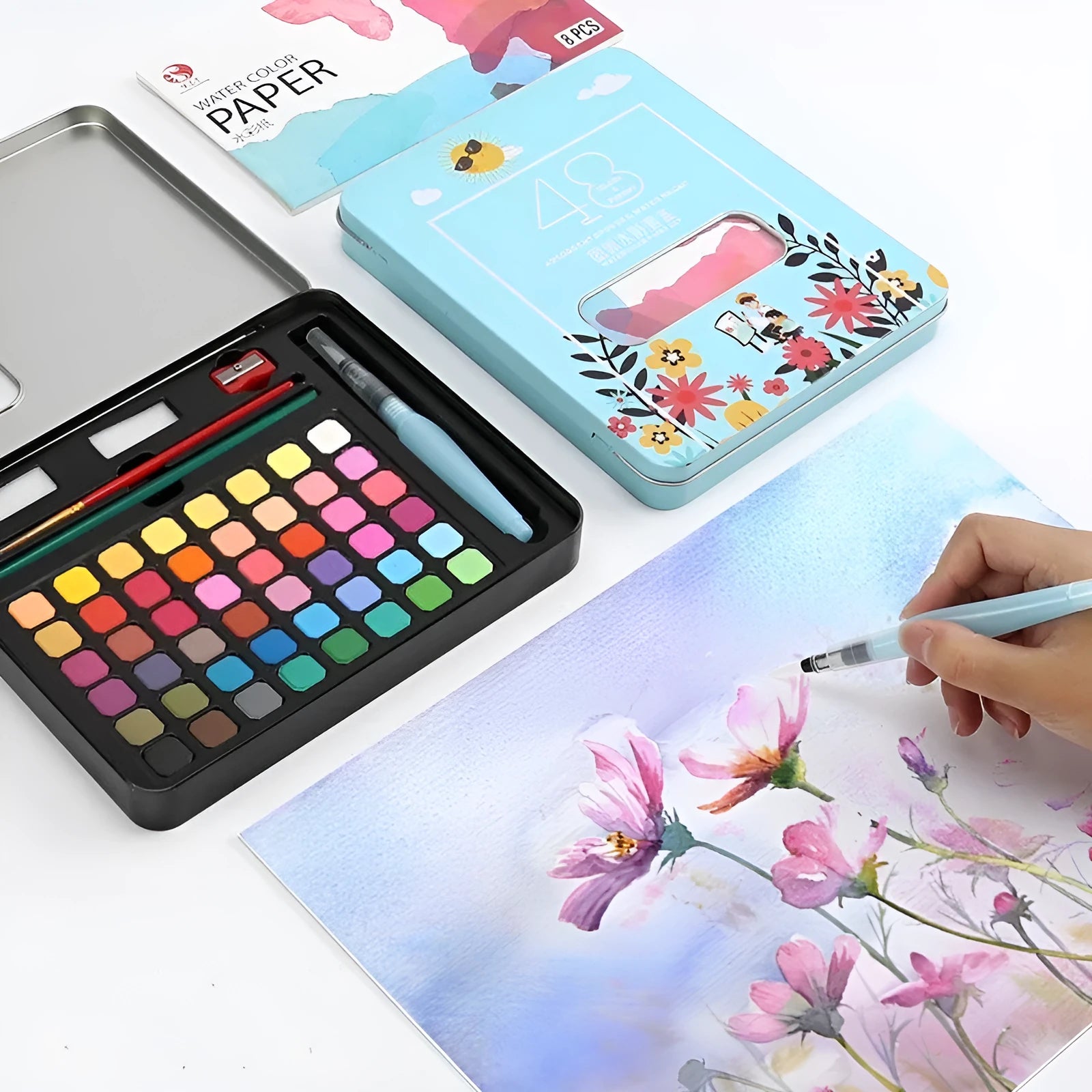 Solid watercolour paint set open to show 48 different colour pans in a box