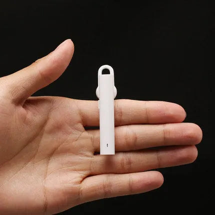 Compact black and white wireless Bluetooth V4.1 headset earpiece showing scale.