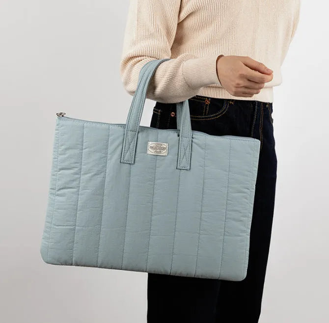 Personalised polyester laptop briefcase in milky white, shown with size options for 11, 13-14, and 15-15.6 inch devices.