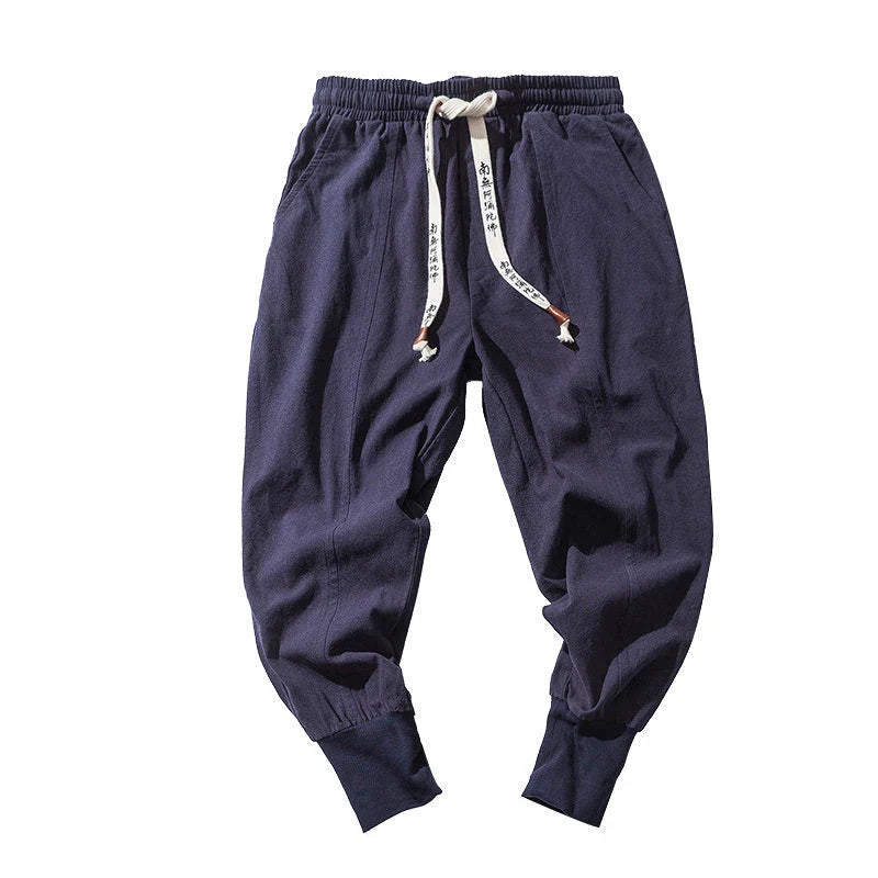 Comfortable linen and cotton harem pants for men, featuring an elastic waistband and a relaxed, trendy silhouette