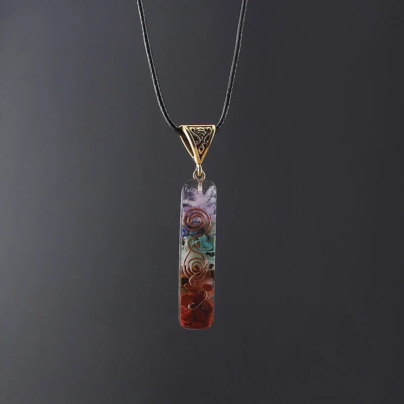 Chakra-inspired acrylic pendant with a unique geometric design and natural variations in the stone patterns