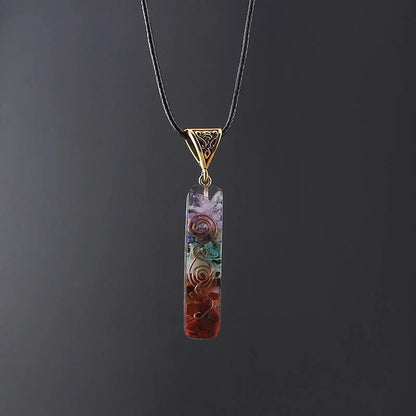 Chakra-inspired acrylic pendant with a unique geometric design and natural variations in the stone patterns