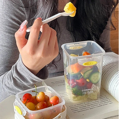 A portable bento box with two compartments for storing different types of food, such as salad, yogurt, oatmeal, and milkshake.