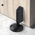 Zinc alloy invisible wedge door stopper in brushed nickel finish on a wooden floor.
