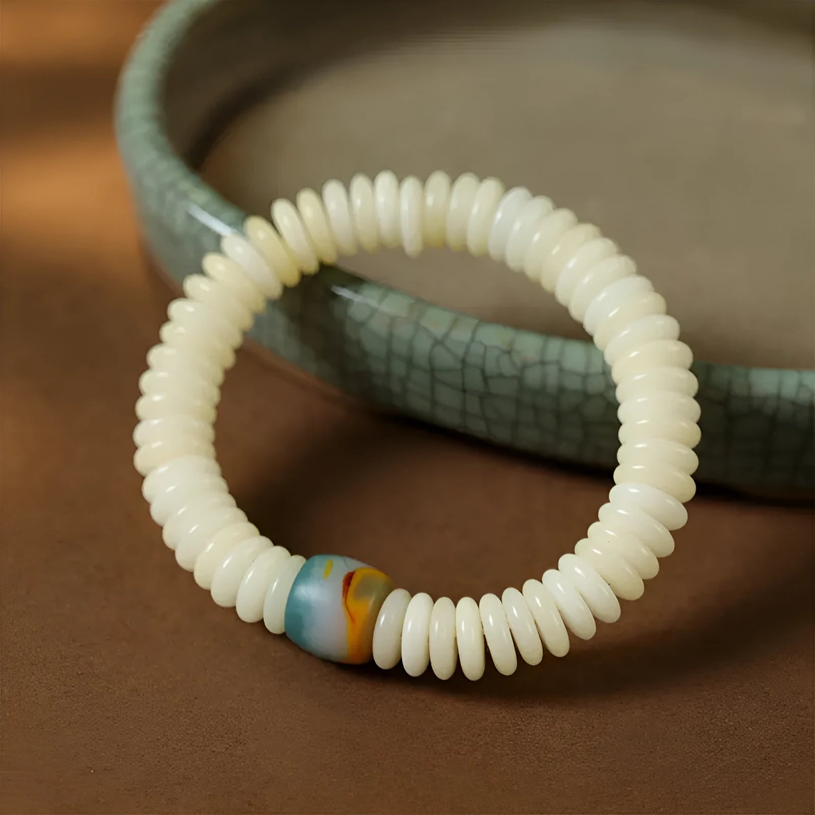 White Bodhi seed bracelet and handheld mala with 3x10mm beads on a neutral background.