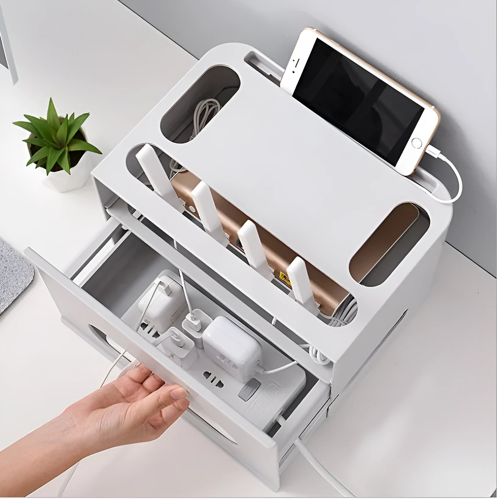 Grey and white plastic router storage box with cable ports for home cable management