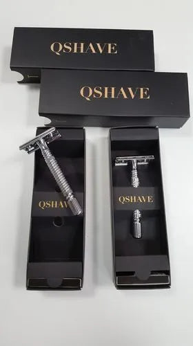 Stainless steel double-edged safety razor with storage box on a bathroom counter.