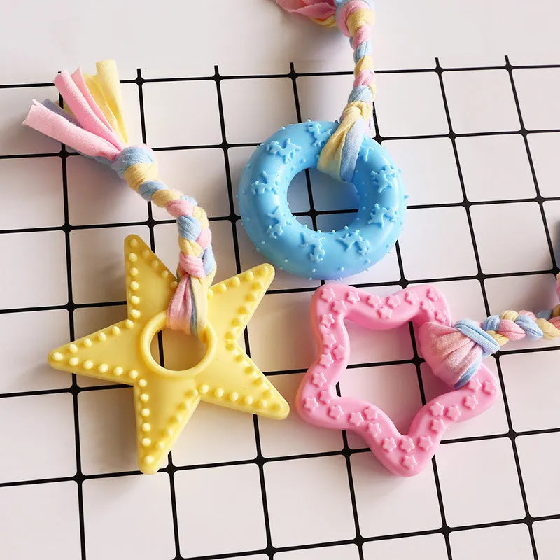 Non-toxic rubber dog chew toy with surface particles, star ring ball shapes, pink blue yellow