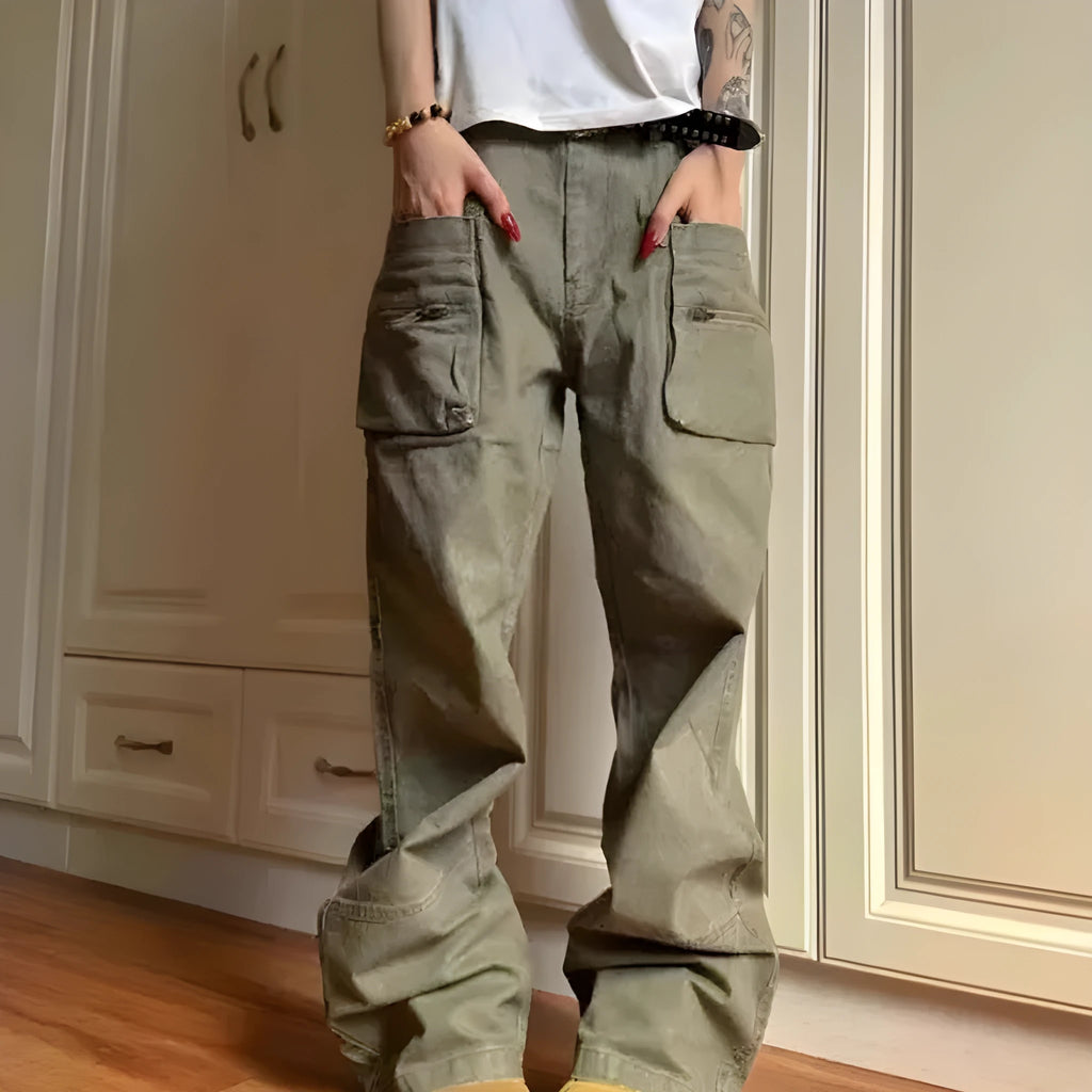 Green and black cotton casual trousers with double zipper detail and pockets on a mid-waist design.
