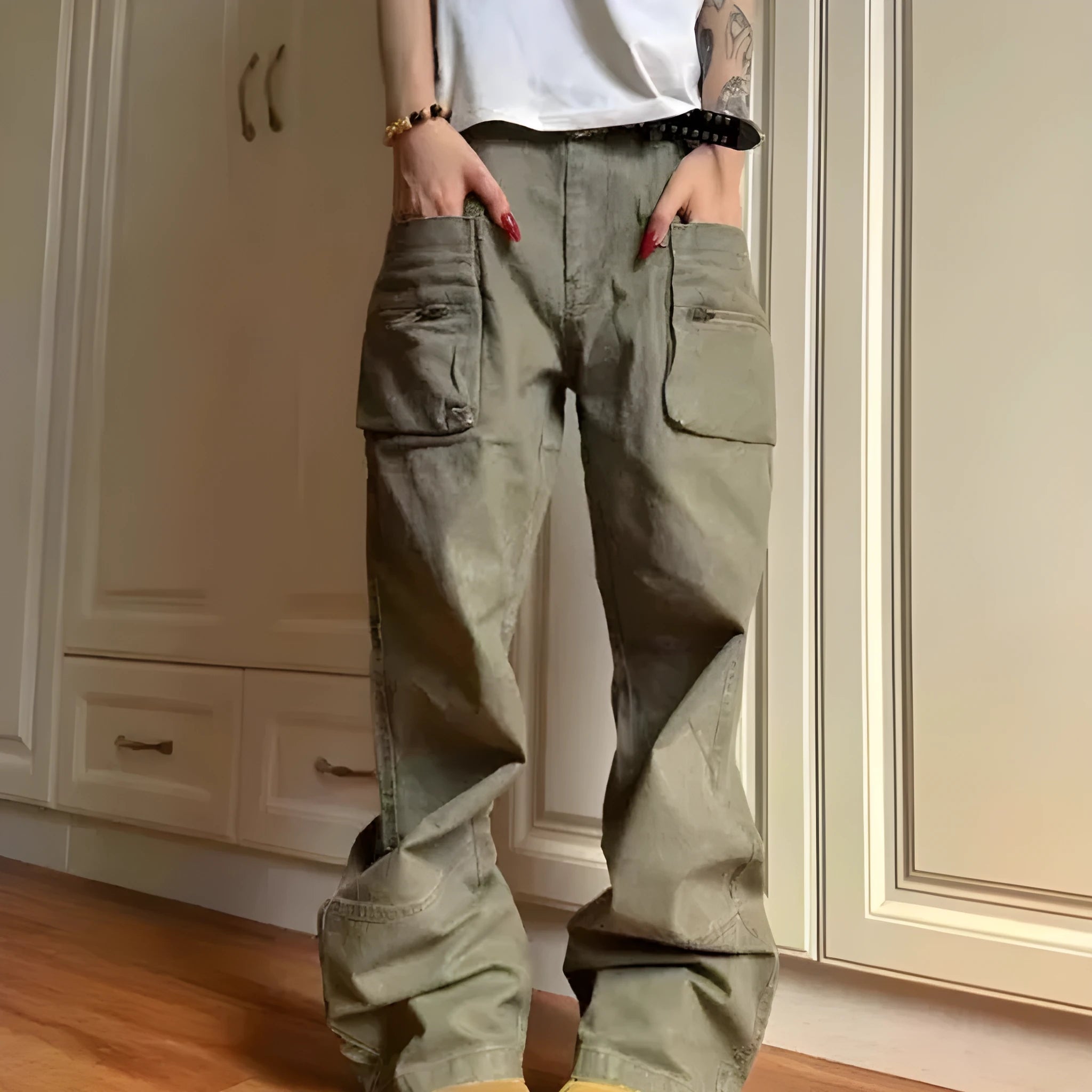 Green and black cotton casual trousers with double zipper detail and pockets on a mid-waist design.