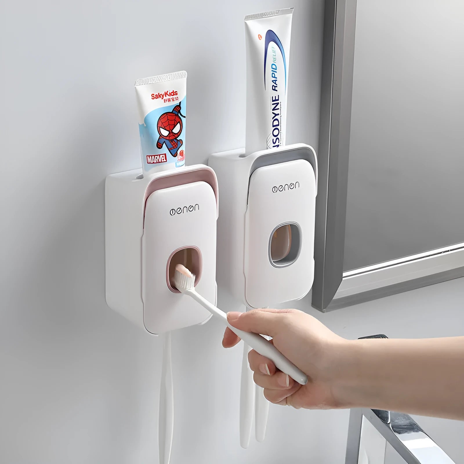 Automatic wall-mounted toothpaste dispenser in blue, grey, or pink ABS plastic with electric pump