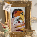 Orange yellow cartoon line art silicone protective case for iPhone on a phone.
