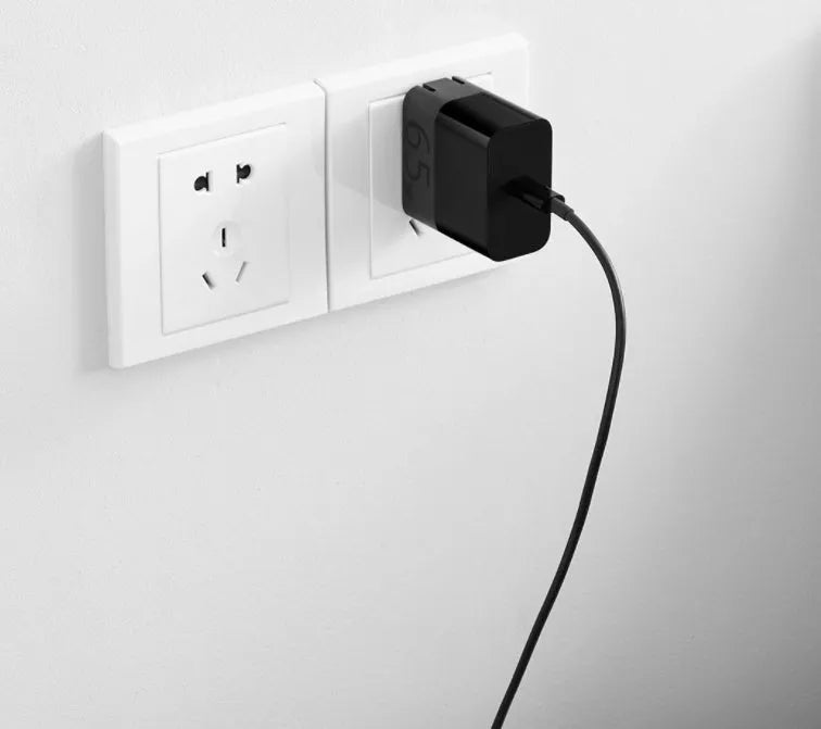 Black ZMI 65W USB-C notebook power adapter with compact design.
