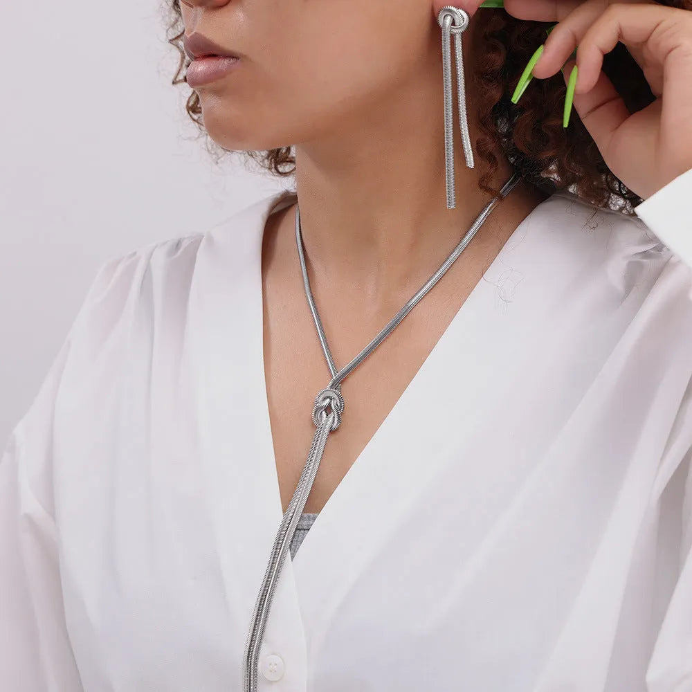 Gold knotted tassel snake chain long necklace with matching electroplated earrings on titanium steel