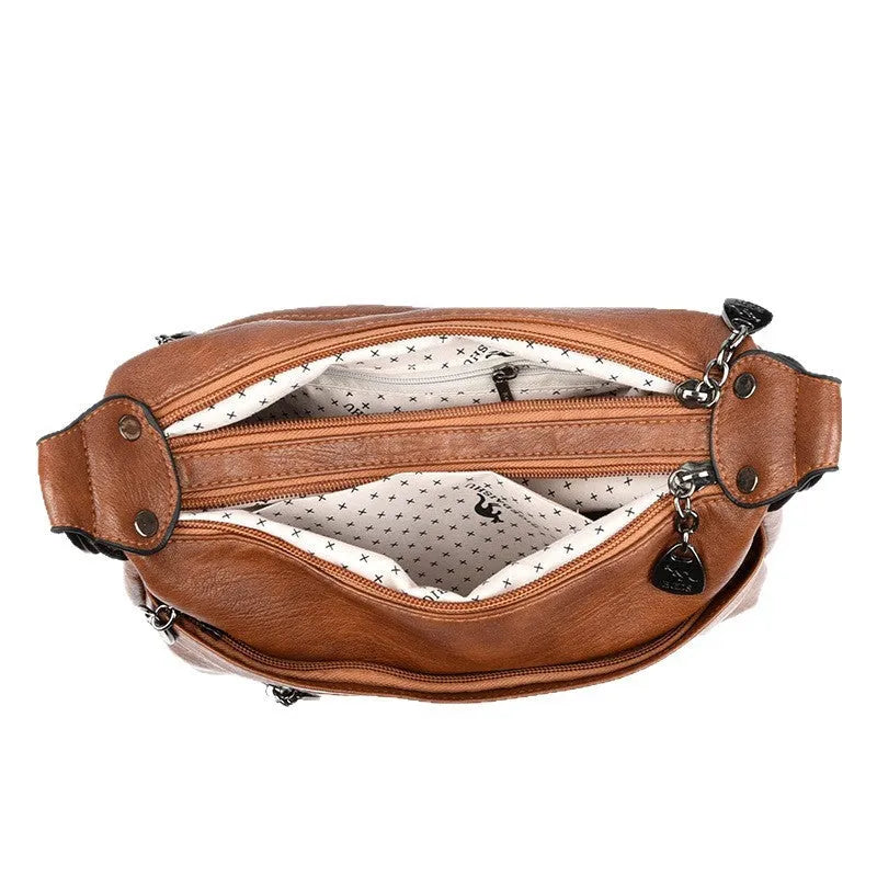 Genuine leather double-sided kangaroo crossbody bag in black with belt decoration and soft sheepskin finish.