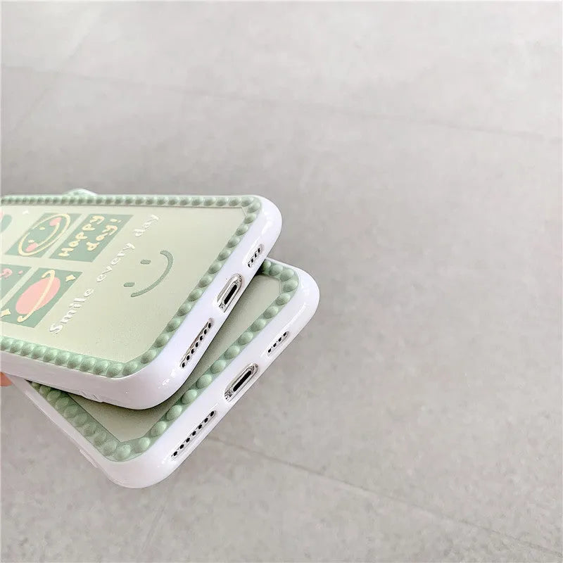 Green soft TPU iPhone case with geometric smiley face and polka dot frame design.