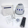 Space Capsule USB Galaxy Projection Lamp in white or grey with remote control on a table.