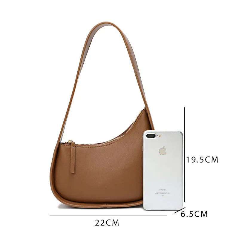 Half moon shaped leather ladies handbag with wide shoulder strap in small size