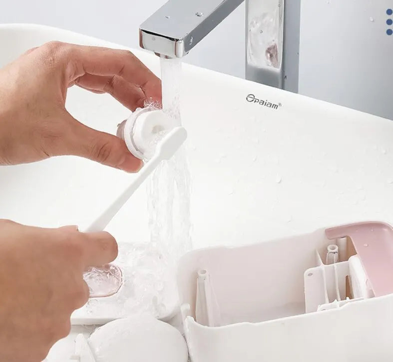 Automatic wall-mounted toothpaste dispenser in blue, grey, or pink colours
