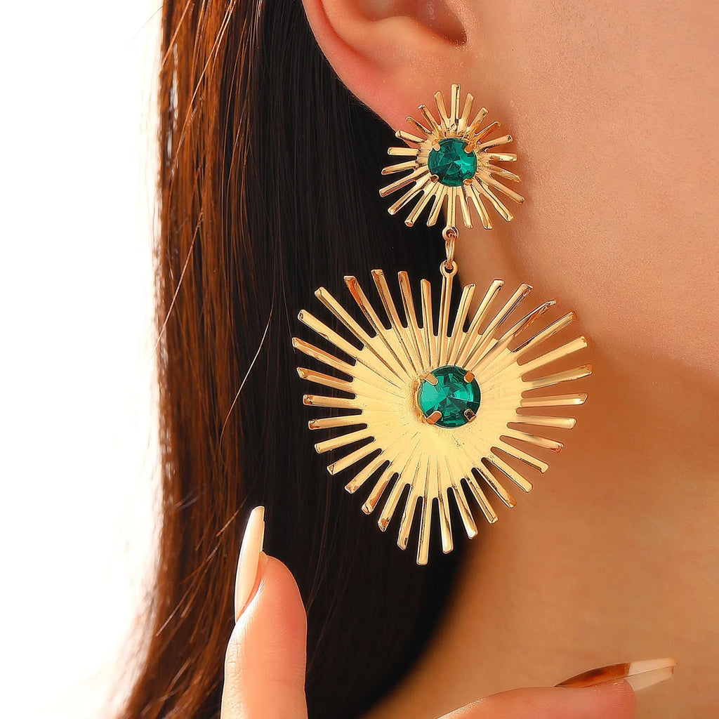 Bohemian sunflower heart-shaped earrings with rhinestones in gold finish on a white background