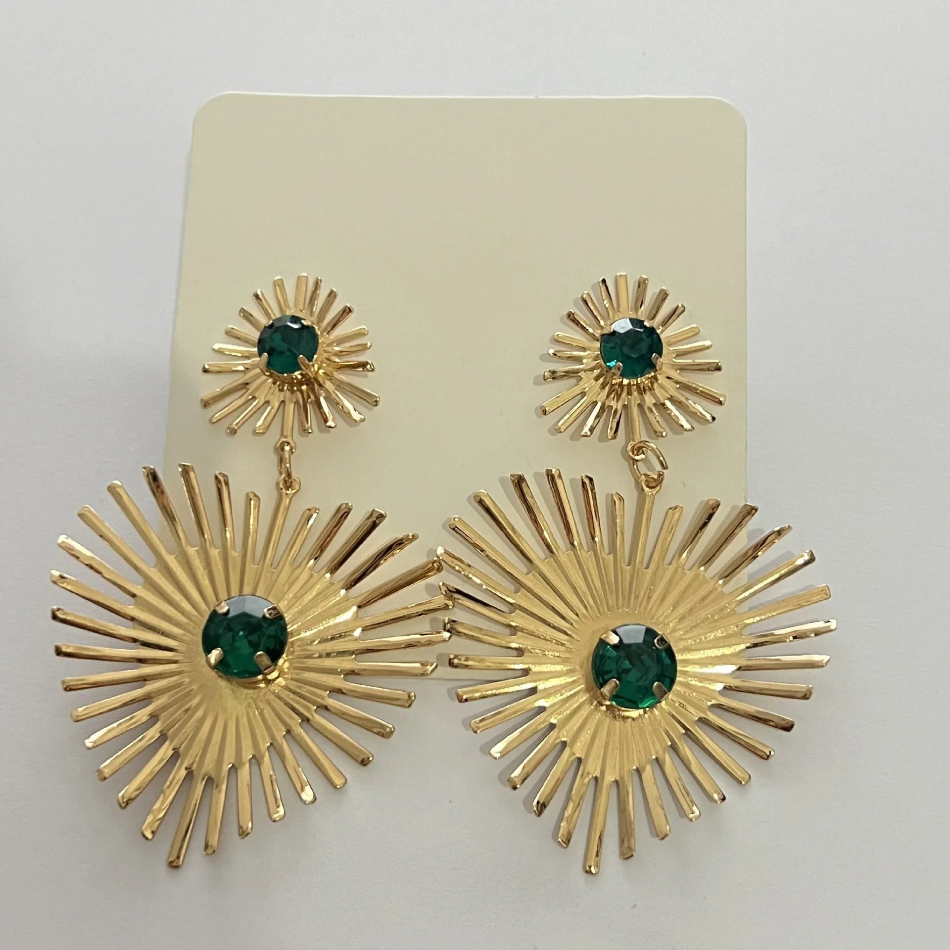 Bohemian sunflower heart-shaped earrings with rhinestones in gold finish on a white background