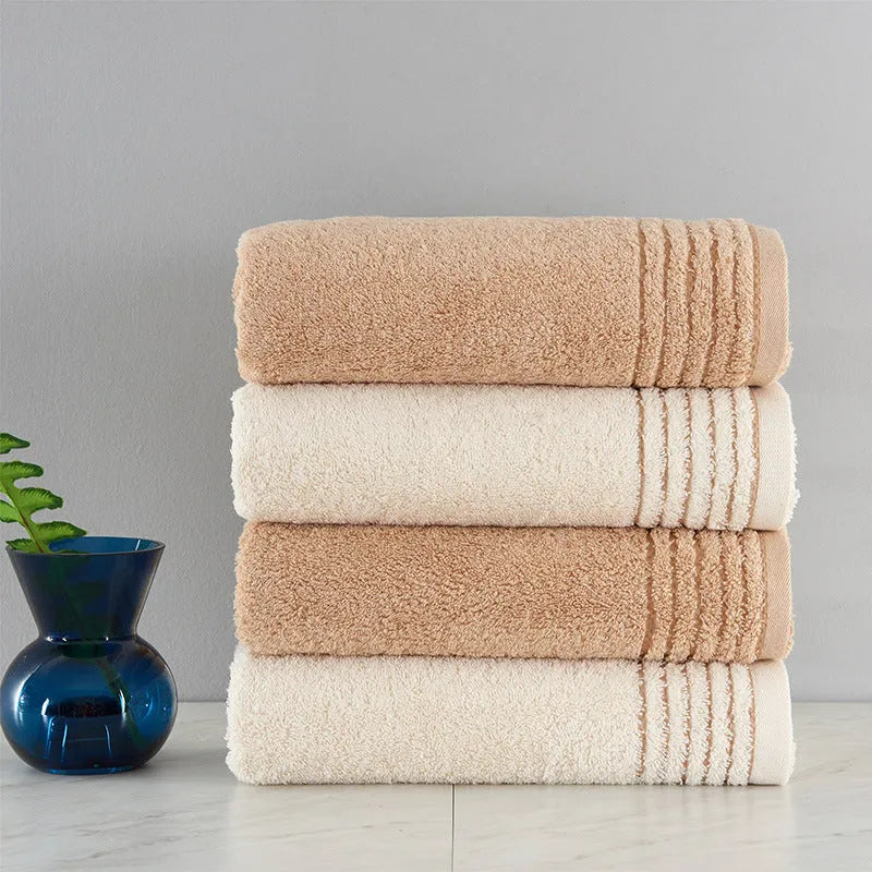 Cotton towel set in beige and brown showing face, hand, and bath towel sizes