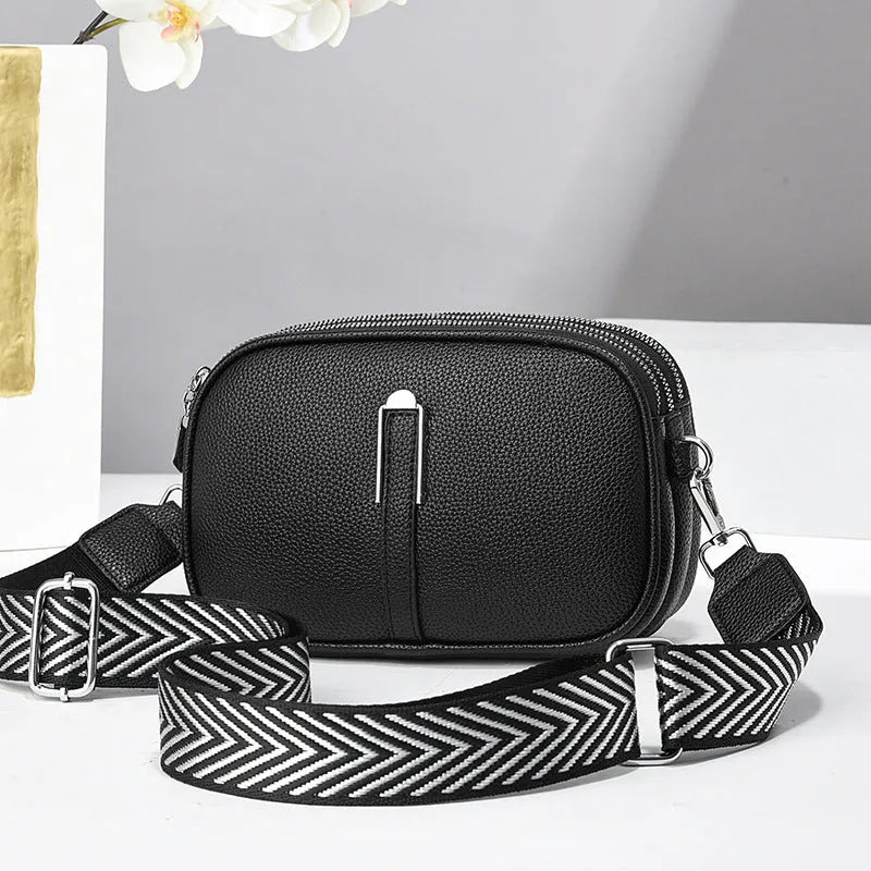 Soft oval PU leather crossbody handbag with stone pattern and internal organiser compartments.