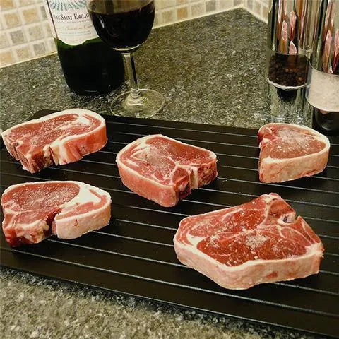 Black aluminium fast defrosting tray for kitchen use on a countertop
