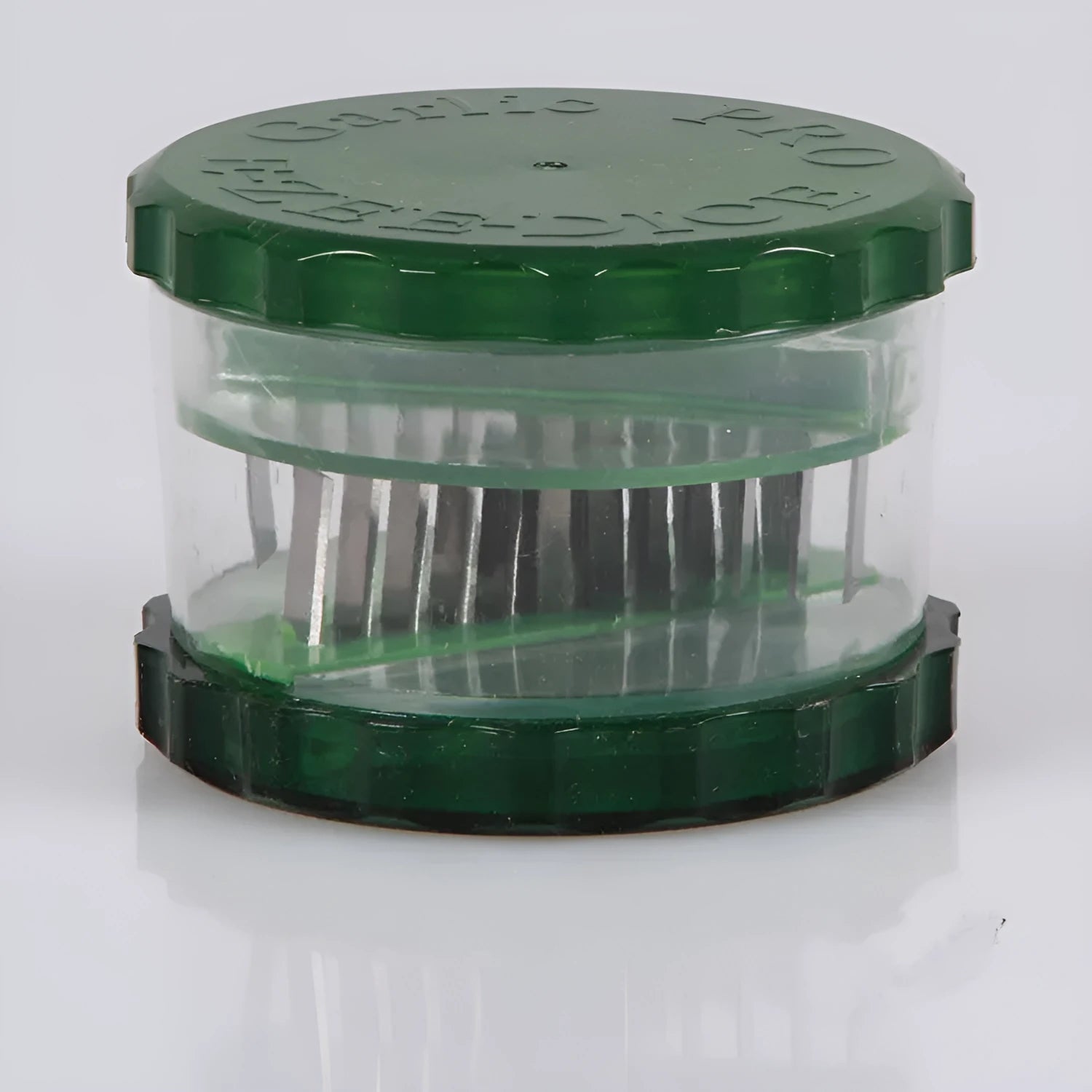 Green transparent plastic garlic peeler with silicone roller for removing skins.