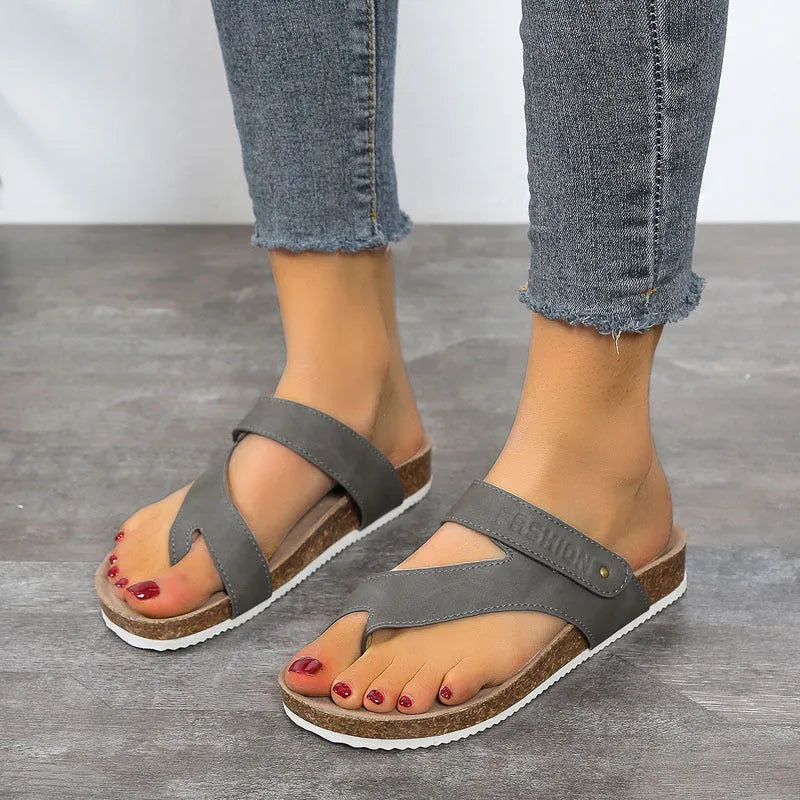 A pair of solid-colour flat toe ring flip-flops with a thick foam sole, shown in blue.