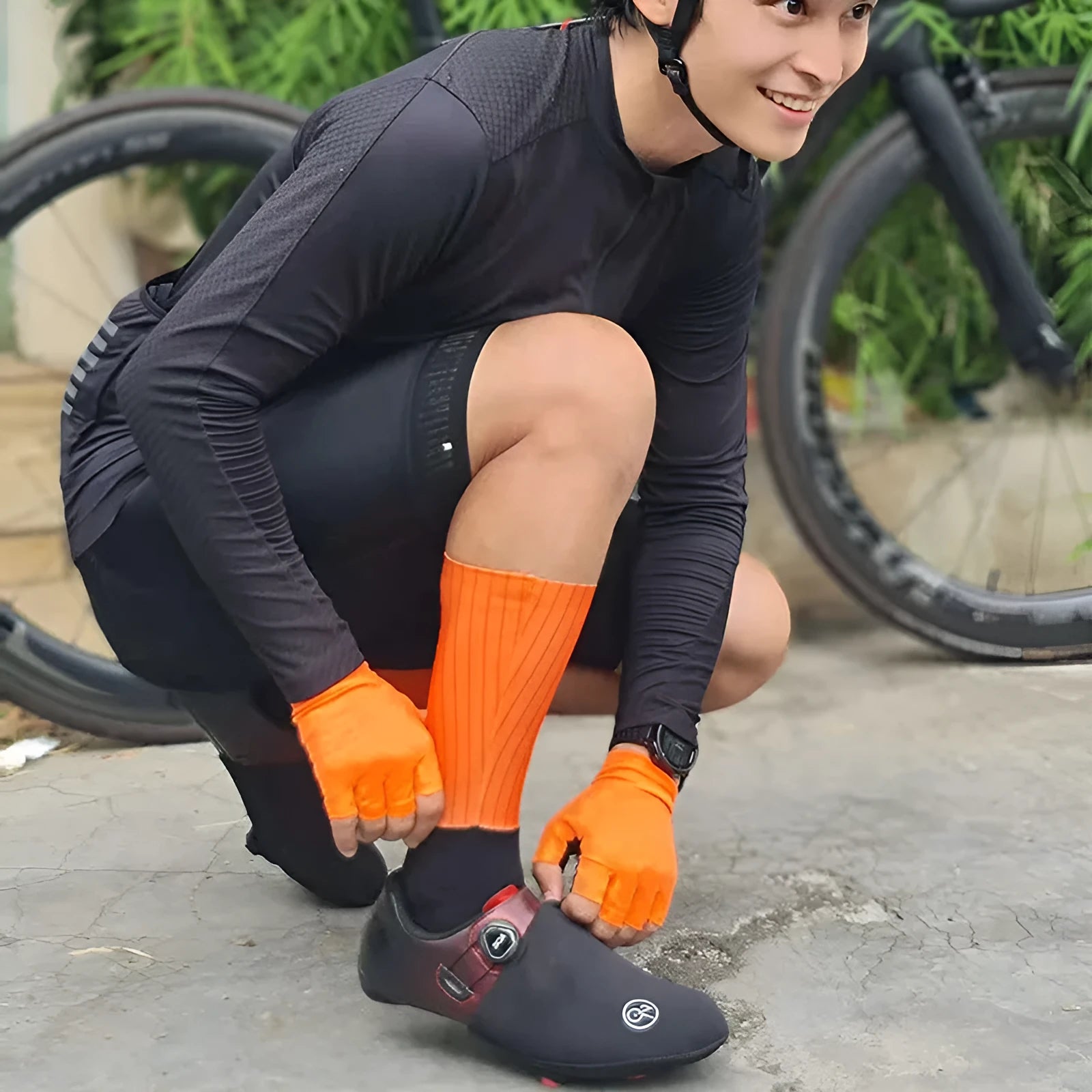 A pair of breathable cycling and running socks in an orange colour on a plain background.