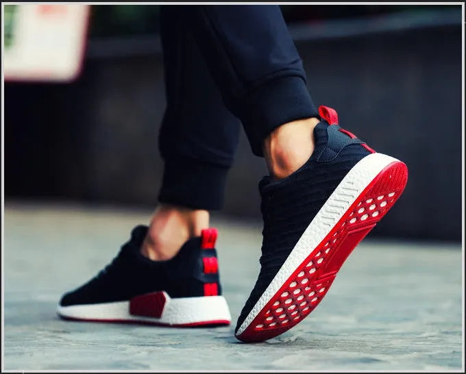 Men Malcolm Sneaker in black from side view showing mesh fabric upper and low-top design