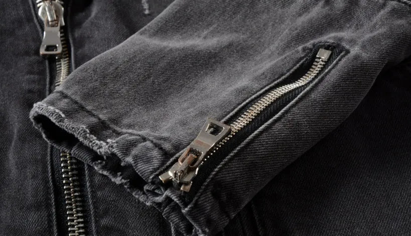 Black denim jacket with lapel collar, zip placket, long sleeves and zipper pockets, slim fit