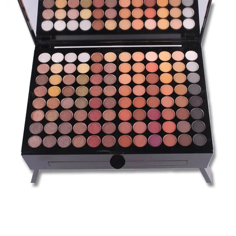 Open piano-shaped makeup palette showing rows of 190 coloured eyeshadow, blush, and powder pans