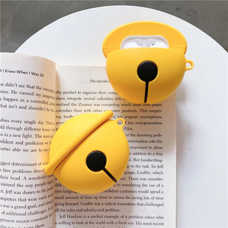 Yellow silicone protective case for AirPods 1 and 2 with a small bell charm attached.