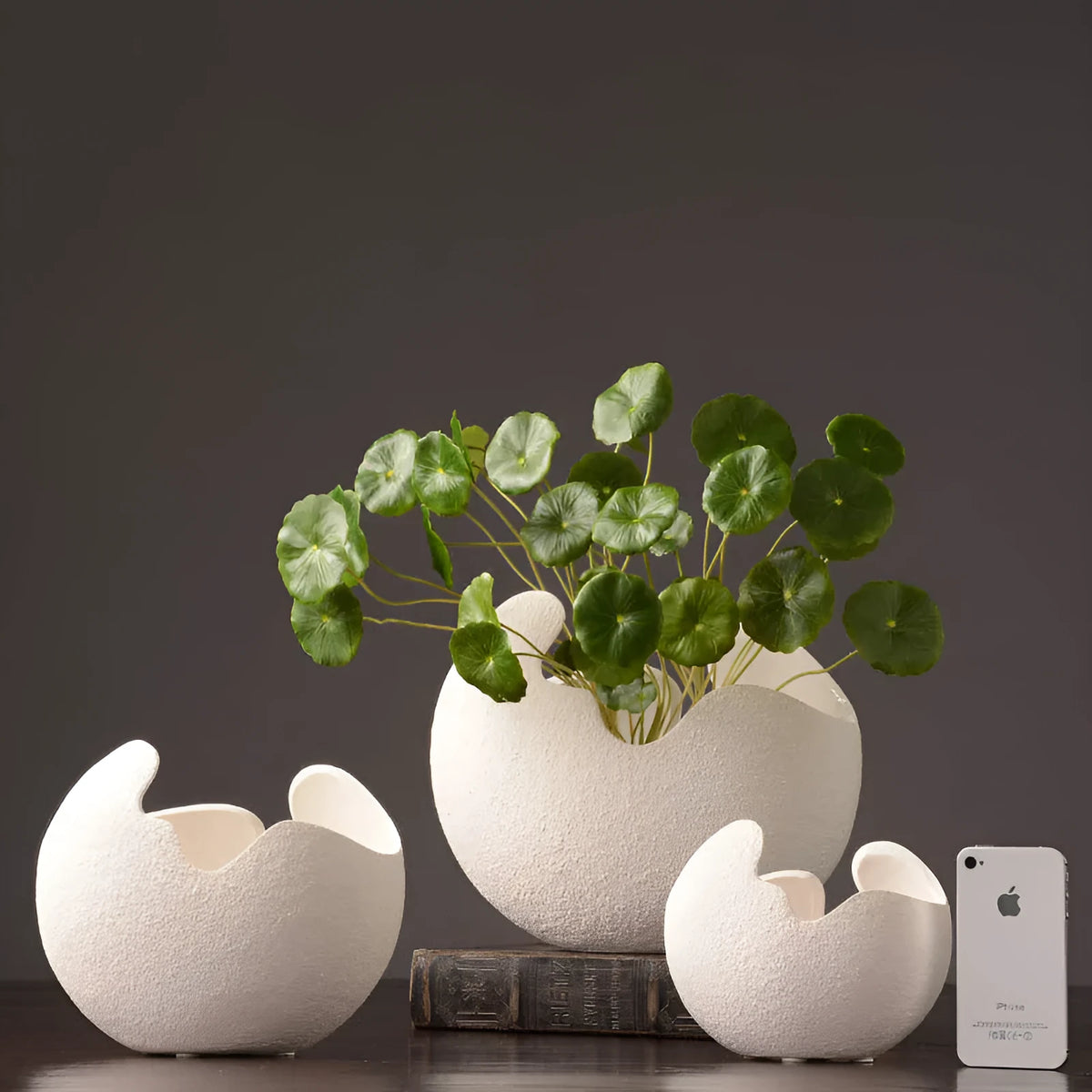 White ceramic countertop vase in simple modern style, shown in large medium and small sizes for living room desktop or study