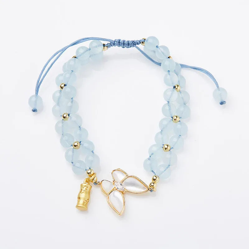 Handmade women's woven bracelet with 6mm aquamarine beads and butterfly decoration in retro style