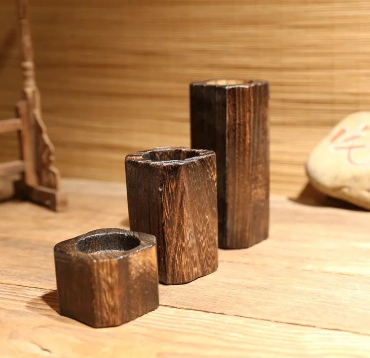 Solid wood candle holder in natural paulownia with charcoal-fired finish, 6x6cm top and 4.5cm candle aperture.