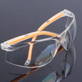 Transparent safety goggles with yellow frame made from impact-resistant polycarbonate