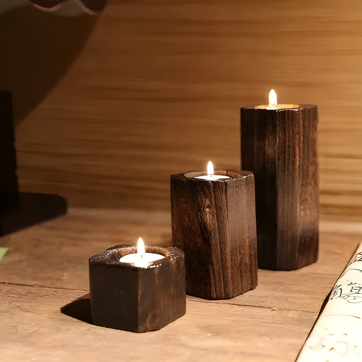Solid wood candle holder in natural paulownia with charcoal-fired finish, 6x6cm top and 4.5cm candle aperture.