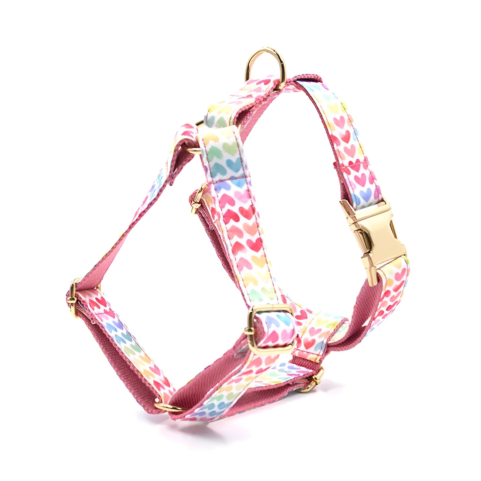 Pink dog harness with gold buckle and heart-shaped stone decoration on a chest and back strap