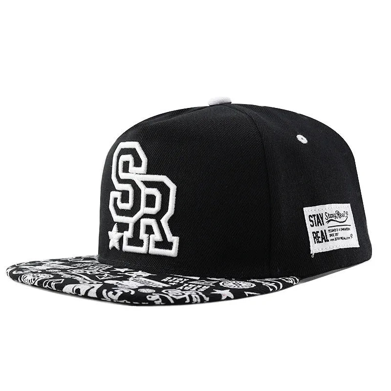 Black and white adjustable cotton baseball cap with embroidered lettering and dome crown.