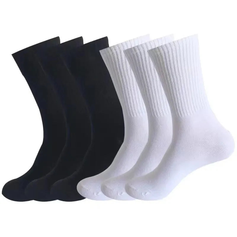 A pair of black mid-calf sports socks made from polyester cotton fabric.