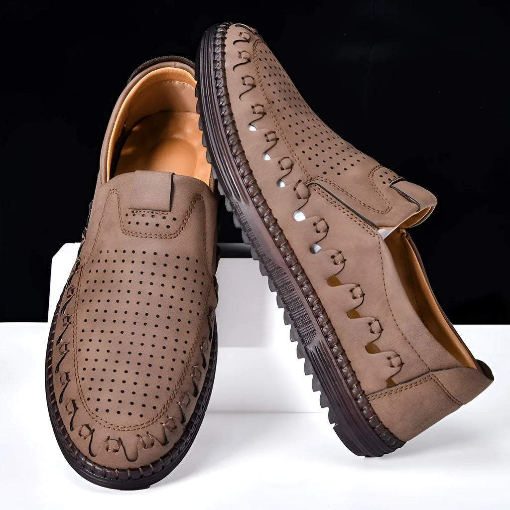 Men's brown slip-on casual shoes with a round toe and flat heel, showing hollowed-out design details.