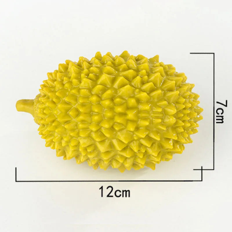 Durian-shaped dog chew toy in bright colours with teeth-cleaning ridges and squeaker ball