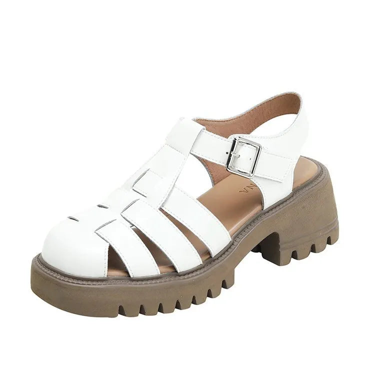 Women's black retro platform sandals with closed toe, hollow out holes, and a silver buckle closure on a chunky rubber heel.