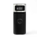 Black portable wireless smart vehicle air pump with USB cable and multiple inflation nozzles on a grey background.