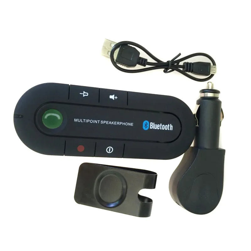 Black vehicle-mounted Bluetooth handsfree unit clipped to a car sun visor, with car charger and cable.