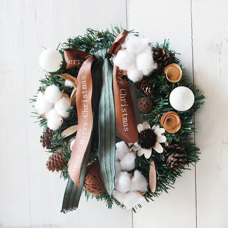 Festive Christmas wreath with artificial pine cones, berries, and maple leaves for elegant holiday decor