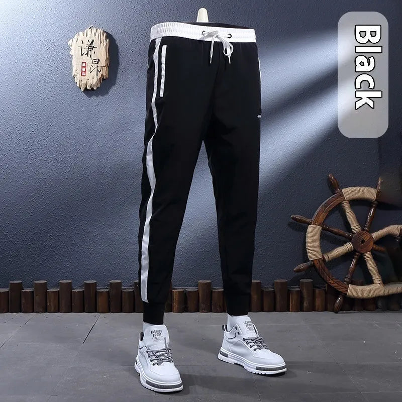 Ice silk breathable stretch ankle-tied skinny sports trousers for men in black striped pattern
